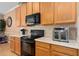 Kitchen featuring stainless steel appliances, wooden cabinets, and sleek countertops at 920 Nola Dr, Ocoee, FL 34761