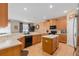 Bright kitchen with stainless steel appliances, wooden cabinets, and island with breakfast bar at 920 Nola Dr, Ocoee, FL 34761