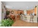 Open-concept kitchen and dining area with tile flooring, stainless steel appliances, and breakfast bar seating at 920 Nola Dr, Ocoee, FL 34761