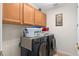 Functional laundry room with cabinetry and modern washer and dryer units for convenience and organization at 920 Nola Dr, Ocoee, FL 34761