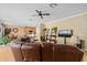 Spacious living room featuring tile floors, a ceiling fan, and a comfortable brown leather sofa at 920 Nola Dr, Ocoee, FL 34761