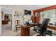 Functional home office with desk, chair, mounted television, and natural light at 920 Nola Dr, Ocoee, FL 34761