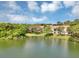 Aerial shot of waterfront condo complex surrounded by lush greenery and a serene lake at 980 Mooring Ave # 105, Altamonte Springs, FL 32714