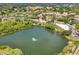Aerial view of the Key West Condominiums with lake and mature trees at 980 Mooring Ave # 105, Altamonte Springs, FL 32714
