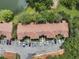 Aerial view of complex with mature trees, ample parking, and serene pond at 980 Mooring Ave # 105, Altamonte Springs, FL 32714