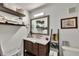 Functional bathroom featuring dark wood vanity, decorative mirror and ladder, and ample storage space at 980 Mooring Ave # 105, Altamonte Springs, FL 32714