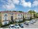 Well-maintained multi-unit condo complex featuring a red tile roof and ample parking at 980 Mooring Ave # 105, Altamonte Springs, FL 32714