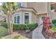 Inviting condo exterior featuring a beige facade, bay window, and lush landscaping at 980 Mooring Ave # 105, Altamonte Springs, FL 32714