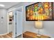 Hallway with an artful painting and an open door to the bathroom at 980 Mooring Ave # 105, Altamonte Springs, FL 32714