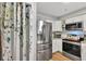 Bright kitchen featuring stainless steel appliances, white cabinetry, and a stylish subway tile backsplash at 980 Mooring Ave # 105, Altamonte Springs, FL 32714