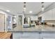 The open-concept kitchen is enhanced by granite countertops, white cabinets, and stainless steel appliances at 980 Mooring Ave # 105, Altamonte Springs, FL 32714