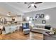 Open-concept living room and kitchen with a large island, comfortable seating, and modern finishes at 980 Mooring Ave # 105, Altamonte Springs, FL 32714