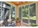 Relaxing screened porch featuring tile floors and views of lush greenery and a serene lake at 980 Mooring Ave # 105, Altamonte Springs, FL 32714