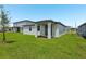 Home featuring expansive backyard lawn and rear exterior view at 4532 Windy Oak Way, St Cloud, FL 34772