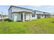 A home's backyard featuring a well-maintained lawn and a covered patio area at 4532 Windy Oak Way, St Cloud, FL 34772