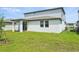 Exterior view of the backyard featuring a well maintained lawn and covered patio at 4532 Windy Oak Way, St Cloud, FL 34772