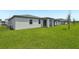 Backyard featuring an expansive lawn with rear view of home at 4532 Windy Oak Way, St Cloud, FL 34772