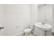 Clean half bathroom featuring a modern toilet and pedestal sink at 4532 Windy Oak Way, St Cloud, FL 34772