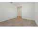 Empty bedroom featuring gray-toned tiled flooring, white walls, and a large doorway at 4532 Windy Oak Way, St Cloud, FL 34772