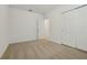 Bedroom with neutral carpeting, white walls, a double door closet, and a doorway at 4532 Windy Oak Way, St Cloud, FL 34772
