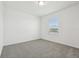 Clean bedroom featuring soft carpet, neutral walls, and a large window offering pleasant natural light at 4532 Windy Oak Way, St Cloud, FL 34772
