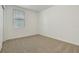 Bedroom with neutral carpeting, a window with blinds and white walls at 4532 Windy Oak Way, St Cloud, FL 34772