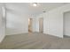 Spacious bedroom features neutral carpeting, white walls, and doorways to the ensuite bath and walk-in closet at 4532 Windy Oak Way, St Cloud, FL 34772