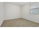 Bedroom with neutral carpeting, a window with blinds and white walls at 4532 Windy Oak Way, St Cloud, FL 34772