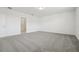 Spacious bedroom showcasing soft carpeting, white walls, and an open doorway to an attached bathroom at 4532 Windy Oak Way, St Cloud, FL 34772