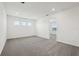 Bright bonus room features plush carpeting, neutral walls, recessed lighting, and ample natural light from three windows at 4532 Windy Oak Way, St Cloud, FL 34772