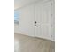 The bright entryway features a white door, window, and neutral walls, complementing the tiled flooring at 4532 Windy Oak Way, St Cloud, FL 34772