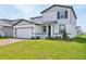 Charming two-story home showcasing a well-manicured lawn, brick paved driveway, and attached two car garage at 4532 Windy Oak Way, St Cloud, FL 34772