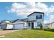 Charming two-story home featuring manicured lawn, brick paved driveway, and attached two car garage at 4532 Windy Oak Way, St Cloud, FL 34772