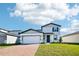 Charming two-story home featuring manicured lawn, brick paved driveway, and attached two car garage at 4532 Windy Oak Way, St Cloud, FL 34772
