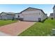 A well-maintained single-Gathering home featuring a two-car garage and brick-paved driveway at 4532 Windy Oak Way, St Cloud, FL 34772