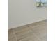 Close up of gray-toned tiled flooring with white baseboards and bright natural light at 4532 Windy Oak Way, St Cloud, FL 34772