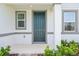 Close up of the front entrance showing the front door, sidelight windows and trimmed shrubs at 4532 Windy Oak Way, St Cloud, FL 34772