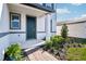 Inviting front porch features brick pathway, lush landscaping, and a stylish front door with sidelight window at 4532 Windy Oak Way, St Cloud, FL 34772