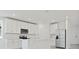 Modern kitchen with white cabinets, stainless steel appliances, and center island with sink at 4532 Windy Oak Way, St Cloud, FL 34772
