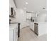 Modern kitchen featuring an island, stainless steel appliances, white cabinets and tile floors at 4532 Windy Oak Way, St Cloud, FL 34772