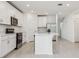 Modern kitchen with stainless steel appliances, a large island, and plenty of cabinet space at 4532 Windy Oak Way, St Cloud, FL 34772