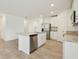 Open kitchen showcasing a stainless steel dishwasher and refrigerator, and a granite countertop island at 4532 Windy Oak Way, St Cloud, FL 34772