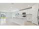 Modern kitchen with white cabinets, stainless steel appliances, and center island with sink at 4532 Windy Oak Way, St Cloud, FL 34772