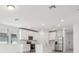 Bright white kitchen features stainless appliances, a center island, and plenty of natural light at 4532 Windy Oak Way, St Cloud, FL 34772