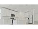 Modern kitchen with white cabinets, stainless steel appliances, and center island with sink at 4532 Windy Oak Way, St Cloud, FL 34772