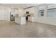 Bright kitchen showcasing a stainless steel refrigerator and a granite countertop island at 4532 Windy Oak Way, St Cloud, FL 34772
