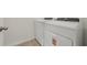 The laundry room showcases a white washer and dryer set on tiled flooring at 4532 Windy Oak Way, St Cloud, FL 34772