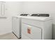 Modern laundry room featuring new white washer and dryer units at 4532 Windy Oak Way, St Cloud, FL 34772