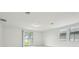 Bright living room featuring light wood-look flooring and sliding glass doors to the backyard at 4532 Windy Oak Way, St Cloud, FL 34772