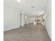 Open floor plan with view of the kitchen featuring modern tiled floors and bright white walls at 4532 Windy Oak Way, St Cloud, FL 34772